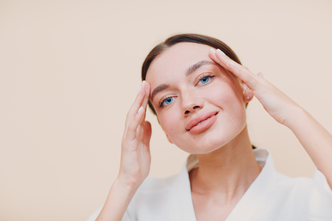 Young caucasian woman doing facebuilding yoga facial gymnastics